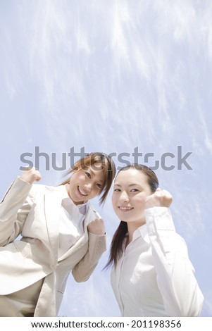Two women taking victory poses