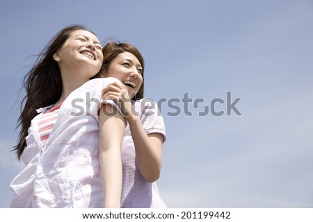 Two laughing women while playing each other