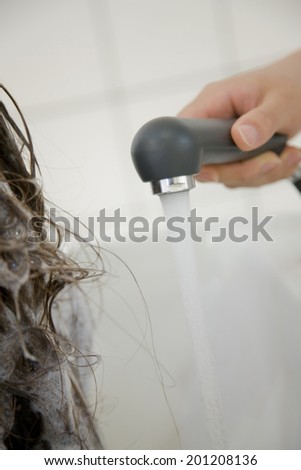 The hand of the hairdresser washing the hair of a women