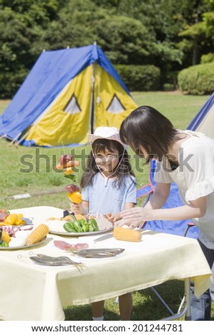 Mother and daughter preparing for the barbecue