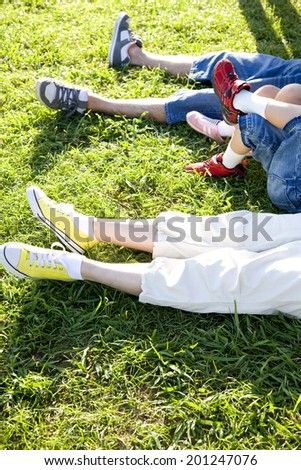 The feet of the family lying down the grass