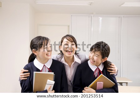 A middle school girl in the arms of an institute teacher