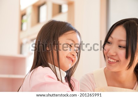 Kindergarten teachers and kindergarten girls smiling