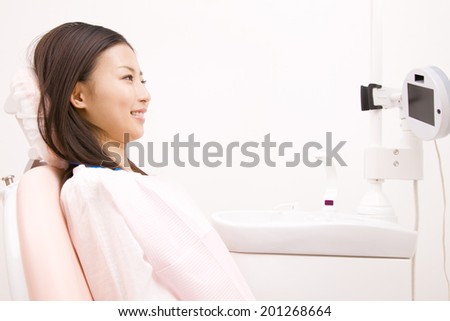 Female patient sitting on dental unit