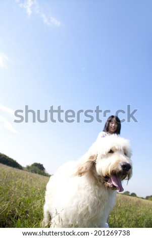 Girl and Golden Doodle taking a walk