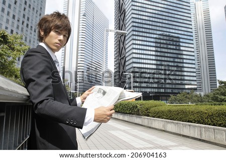 Business Man Reading A Newspaper