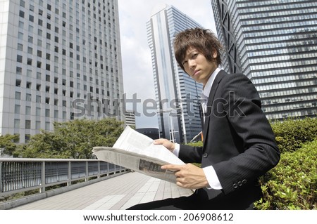 Business Man Reading A Newspaper