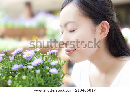 The woman who is going to smell the flowers