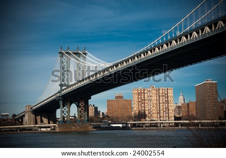 Manhattan Bridge over East River with city on the background
