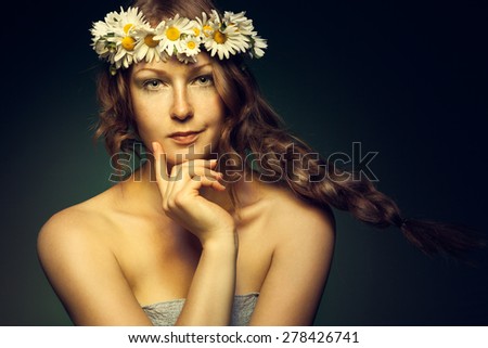 Beautiful woman with wreath of flowers on the head, beauty portrait with chamomiles