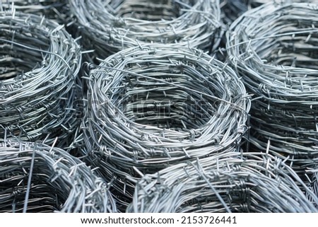 Closeup barbed wire rolled in circle background. Barbed wire is used for make fences , secure property and make border to show the territory of  area.                                Foto stock © 