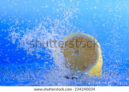 Lemon in water with bubbles. blue background