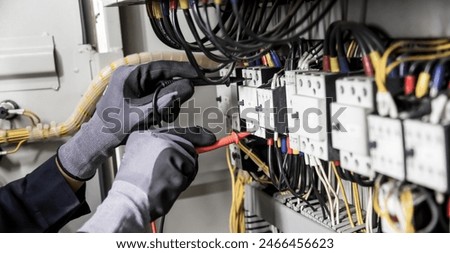 Similar – Image, Stock Photo Electrician working on the distribution panel of a house