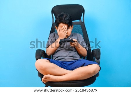 Similar – Image, Stock Photo Serious kid playing with toy at home