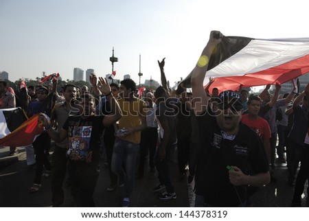 CAIRO - JUNE 30: Anti Muslim Brotherhood/Morsi protesters over Qasr el-Nil bridge shout slogans calling for Morsi\'s resignation on June 30, 2013 in Cairo, Egypt.