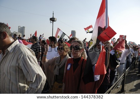 CAIRO - JUNE 30: Unidentified women in the rally over Qasr el-Nil bridge heading to Tahrir Square to join the protesters on June 30, 2013 in Cairo, Egypt.
