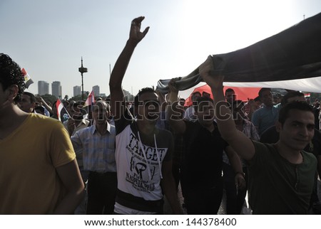 CAIRO - JUNE 30: Anti Muslim Brotherhood/Morsi protesters over Qasr el-Nil bridge shout slogans calling for Morsi\'s resignation on June 30, 2013 in Cairo, Egypt.