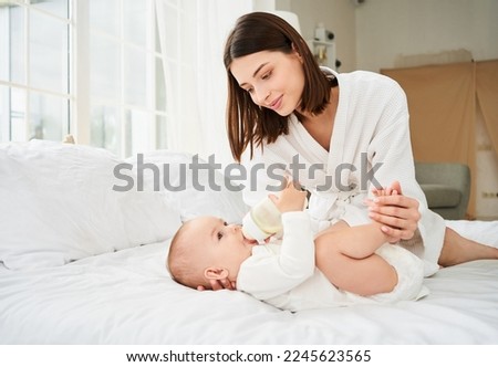 Similar – Image, Stock Photo Mother bottle feeding newborn