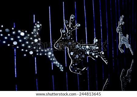 Diamonds Reindeer LED light which run over a reflection water. It one of Bangkok (Thailand) Christmas decoration. blurred