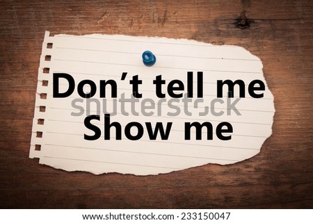don,t tell me show me  text on wood background