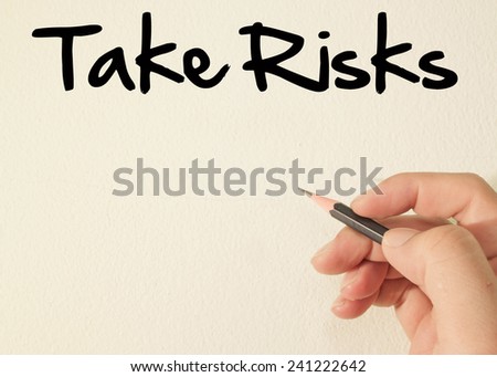 take risks text concept write on wall