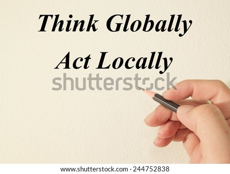 think globally act locally text concept write on wall paper