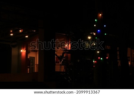 2​ bright​ly​ lit​ window​s, a​ group​ of​ multicolor​ed​ spherical​ lights​ on​ a dark​ background. Stock fotó © 