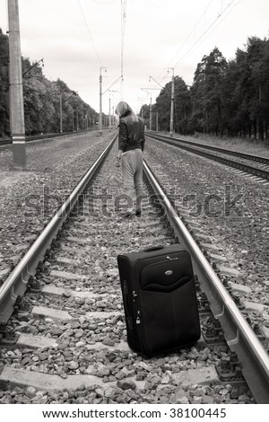 Suitcase standing left on railroad