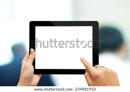 male teen hands with ring using tablet pc on blurred people background