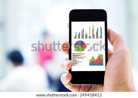 hand holding mobile phone with analyzing graph
