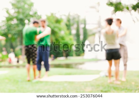 blurred young happy people excercis in the park