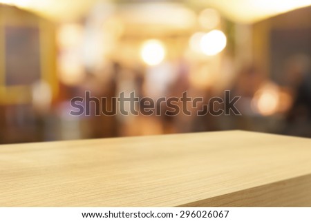 Empty wooden table and blurred cafe background, product display montage