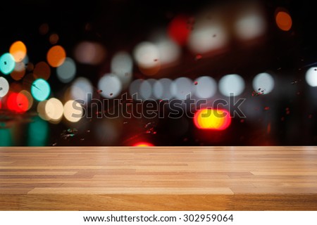 Empty wooden table with colorful  night light bokeh circle shape background. product montage display