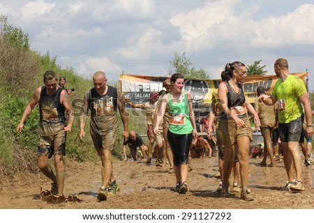 SIGNA, ITALY - MAY 9 2015: People dirt with mud during a Mud Run competition in Italy
