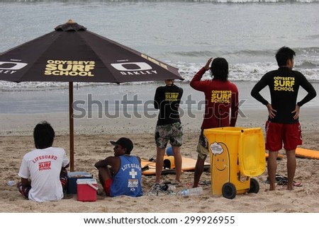 BALI, INDONESIA - JULY 13 2012: Surf school staff on Kuta Beach in Indonesia