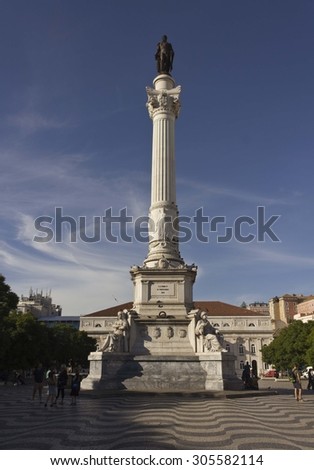 LISBON, PORTUGAL - OCTOBER 23 2014: Column of Pedro IV in Rossio Square in Lisbon with people around the square