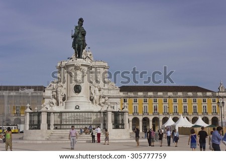 LISBON, PORTUGAL - OCTOBER 24 2014: People walking in Lisbon commercial square, with the King Jose equestrian Statue in the background