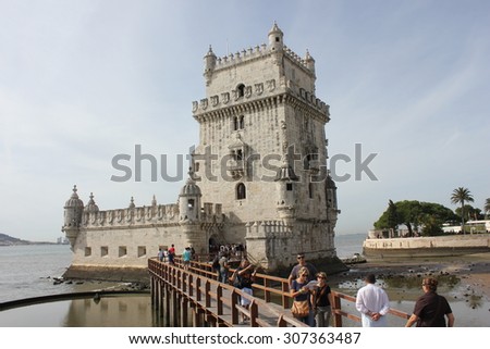 LISBON, PORTUGAL - OCTOBER 24 2014: Belem Tower of Lisbon, Unesco world heritage, with people on the bridge