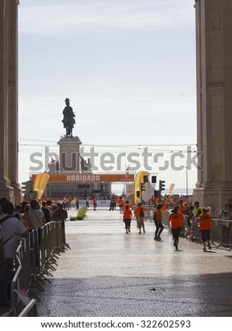 LISBON, PORTUGAL - OCTOBER 26 2014: The finish line of Lisbon Marathon in 2014, in commerce square, with runner arriving at King Jose equestrian statue