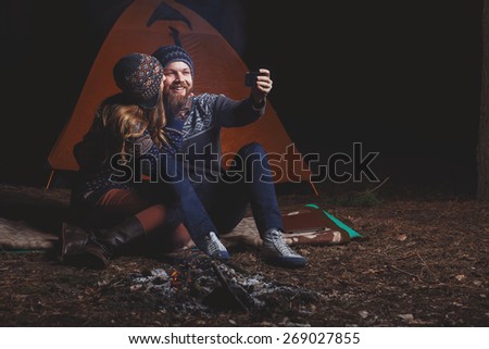 Couple tent camping in the wilderness taking selfie