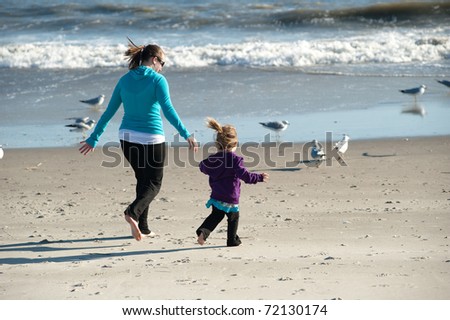 mother and daughter playing at the beach