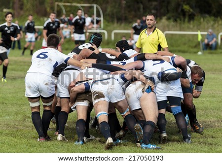 ZAGREB, CROATIA - SEPTEMBER 13, 2014: Rugby match Rugby Club Zagreb in white jersey and Rugby Club Sinj in black jersey. Unidentified player\'s tackle each other