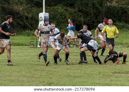 ZAGREB, CROATIA - SEPTEMBER 13, 2014: Rugby match Rugby Club Zagreb in white jersey and Rugby Club Sinj in black jersey. Unidentified player\'s running with the ball.