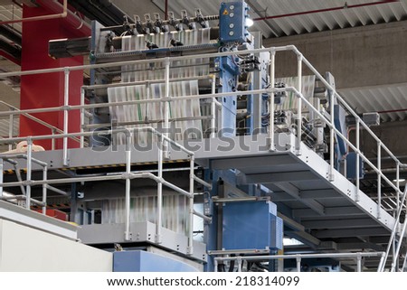 ZAGREB, CROATIA - SEPTEMBER 16, 2014: View of rotation Koenig Bauer machine in Printing house. Printing machine bends paper in full speed, paper is going through serious of rollers