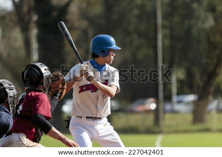 ZAGREB. CROATIA - OCTOBER 11, 2014: Baseball match Baseball Club Zagreb in white jersey and Baseball Club Medvednica in red jersey. Unidentified baseball player preparing himself to hit the ball