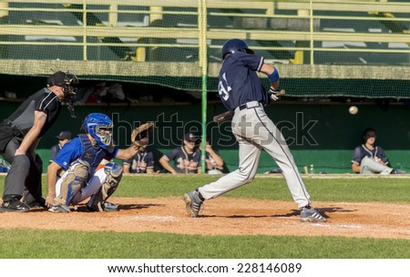 ZAGREB. CROATIA - OCTOBER 12, 2014: Baseball match Baseball Club Zagreb in blue jersey and Baseball Club Olimpija in dark blue jersey. Unidentified baseball batter is about to hit the ball