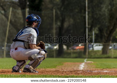ZAGREB, CROATIA - OCTOBER 11, 2014: Baseball match Baseball Club Zagreb in white jersey and Baseball Club Medvednica in red jersey. Unidentified baseball catcher on field