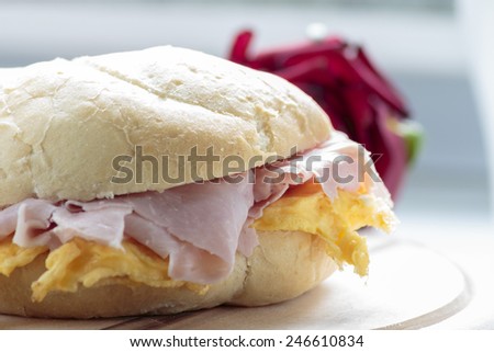 Ham & eggs sandwich on wooden board