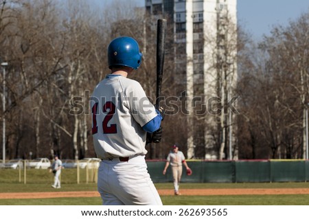 ZAGREB, CROATIA - MARCH 21, 2015: Baseball match Baseball Club Zagreb in blue jersey and Baseball Club Olimpija in gray jersey. Baseball batter is holding bat with both hands