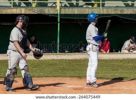ZAGREB, CROATIA - MARCH 21, 2015: Baseball match Baseball Club Zagreb in blue jersey and Baseball Club Olimpija in gray jersey. Baseball batter and baseball catcher standing up